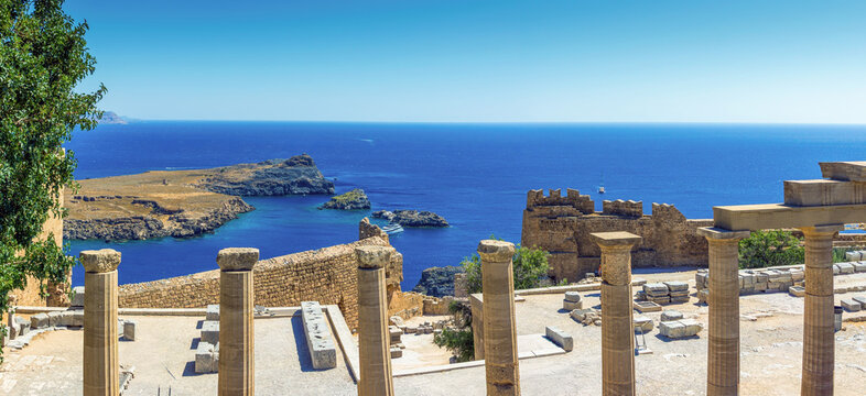 Ancient columns of the Acropolis of Lindos overlooking St Pauls Bay in Rhodes, Greece