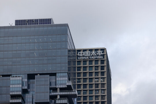 Shenzhen, China &ndash; May 25, 2026: The China Taiping logo sits atop a textured grid building, standing alongside a sleek contemporary glass tower