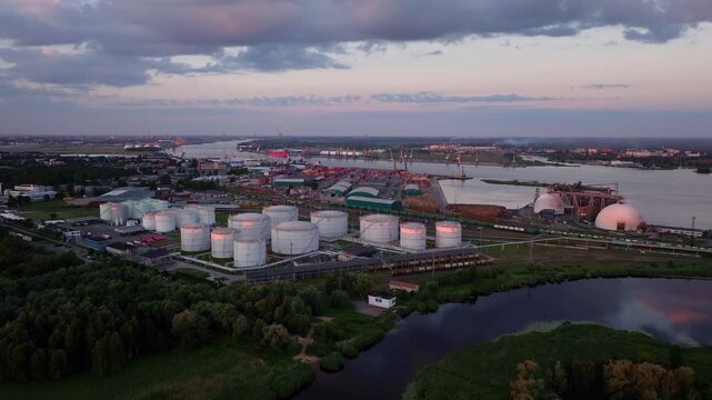 Aerial sunrise panorama of Riga Port with oil storage terminal and cargo harbor on the Daugava River, Latvia