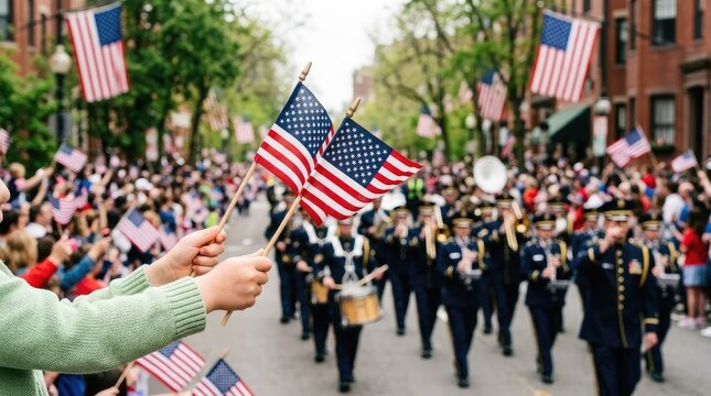 Crowd watching a patriotic parade with marching band and american flags on a city street