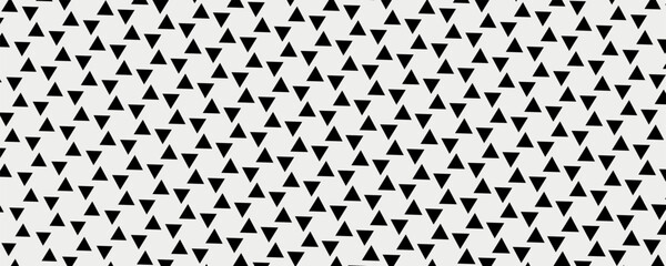 Black and white chess triangles. A vector of identical black triangles on a white canvas. Vector decor with triangles. © yakult