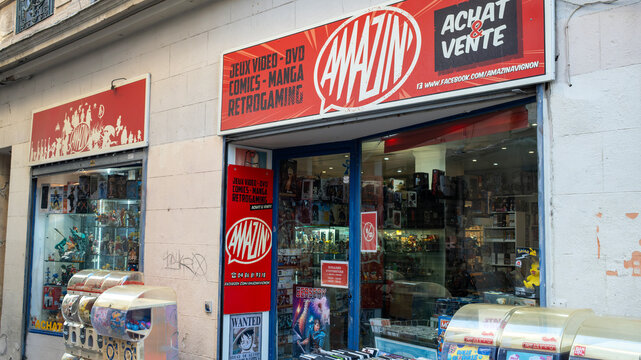 Avignon, France &ndash; December 27, 2025: A vibrant comic and retro gaming shop welcomes visitors with colorful displays along a charming old town street.