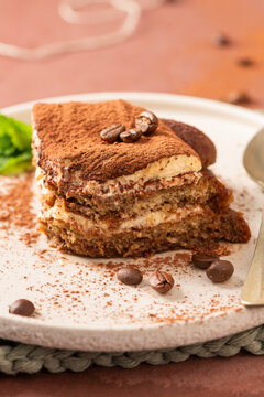 Slice of tiramisu dessert cake with coffee beans