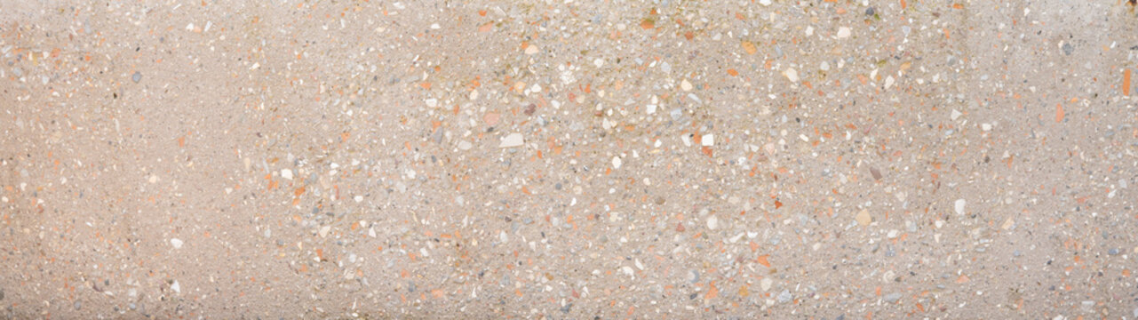 Beige brown natural stone, sandblastet concrete tile wall texture background banner panorama