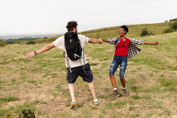 Fototapeta premium Enjoying Time Outdoors With Friends in a Grassy Field During a Sunny Day