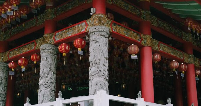 Red lanterns hanging on a carved stone frame at Sam Poo Kong temple, Semarang, Indonesia
