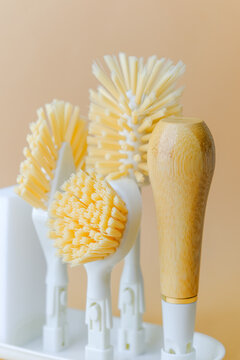 Cleaning brushes with bamboo handle and white bases on a light background