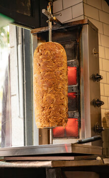 juicy meat on vertical rotisserie for shawarma preparation