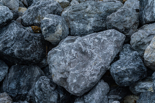 Close-up texture of grey granite rocks and stones background