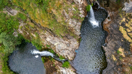 Los Fumos Well Waterfall, Los Bayos, León, Castile and León, Spain, as seen from a drone © AntonioLopez