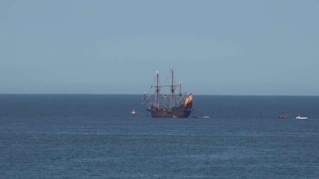 Historic Galleon with Spanish flag sailing close to the coast of Ireland in County Donegal