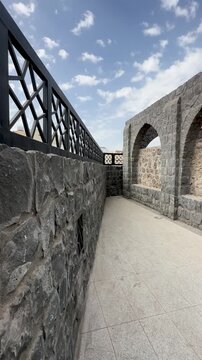 Stone arches and landscaped gardens at the historic Masjid Bani Anif in Medina.