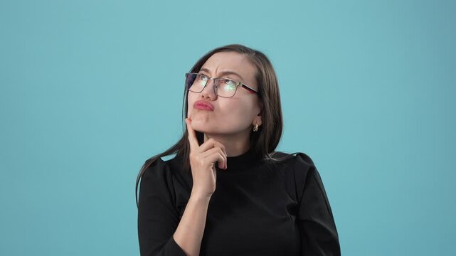 Portrait of an asian woman touching her chin and thinking deeply about a problem