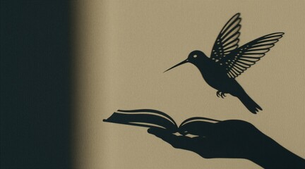 Fototapeta premium Black shadow of flying hummingbird, open book above human hand cast on light wall. Artistic silhouette display creative concept about reading, nature. Minimalist design shows peaceful bird symbol
