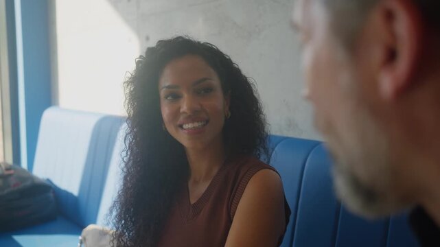 Diverse couple enjoying friendly conversation at modern fast food restaurant