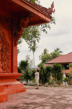 A tourist stands and admires the temple