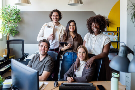 Diverse business team smiling at shared modern office