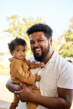 Smiling Dad With Baby Outdoors