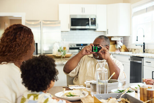 Family Gathers for Dinner in the Kitchen