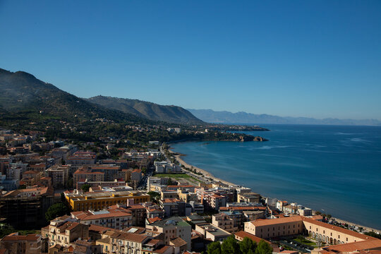 Cefalu Sicily coastal town with medieval cathedral and rocky cliff overlooking the sea and the beautiful beach in the mediterranean sea.