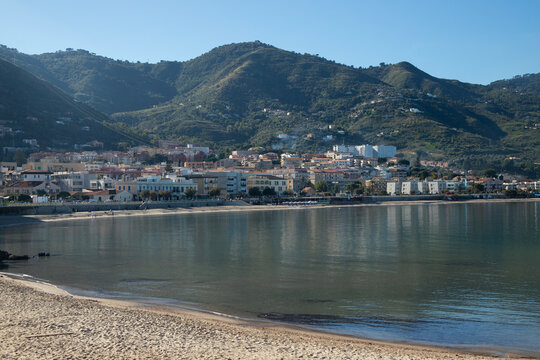Cefalu Sicily coastal town with medieval cathedral and rocky cliff overlooking the sea and the beautiful beach in the mediterranean sea.