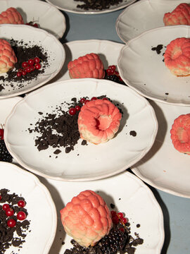 Pink Mini Bundt Cakes Served with Berries and Chocolate Crumble