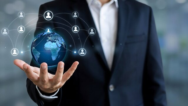 Businessman holding the globe in his hand, network connection of people around the globe, globalization concept