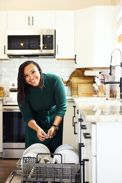 Woman Loading Dishes in Daylight