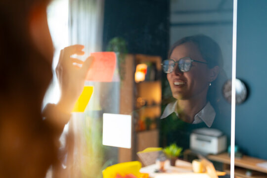 Reviewing Project Ideas on a Glass Board