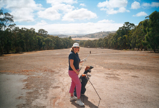 Woman Golfing on a dry summer country golf course