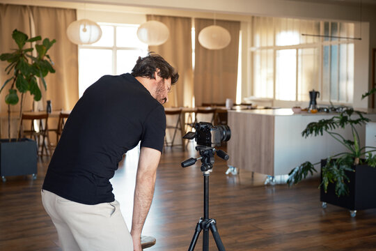 Cameraman preparing equipment For recording indoors