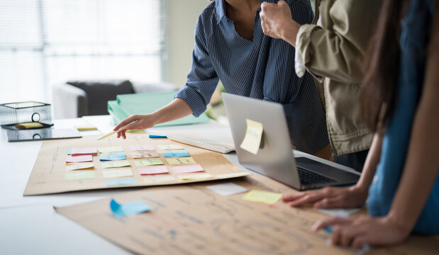 Business hands creating project mind map with colorful sticky notes