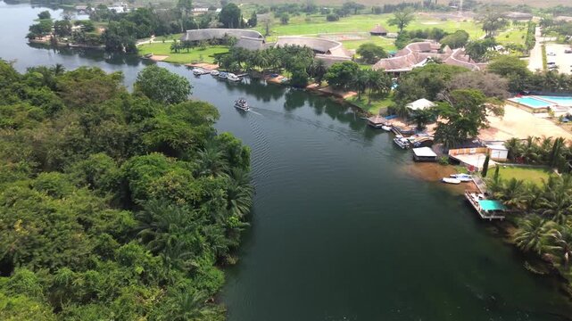 Aerial View of Boat Cruising on Volta Lake Past Resort, Ghana
