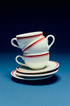 Stacked coffee cups on a blue background