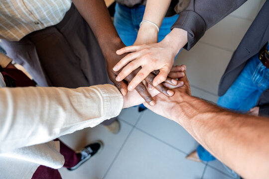 Diverse team hands stacking for unity and collaboration