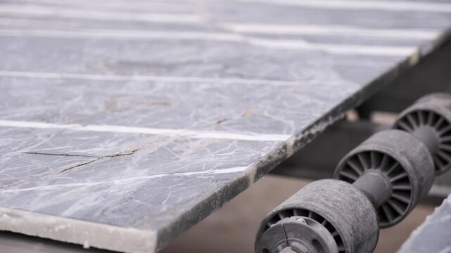 Heavy machinery cutting large marble block in natural stone factory production line