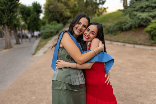 Portrait of happy friends celebrating their university graduation