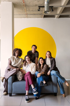 Diverse business team smiling sitting on couch in office