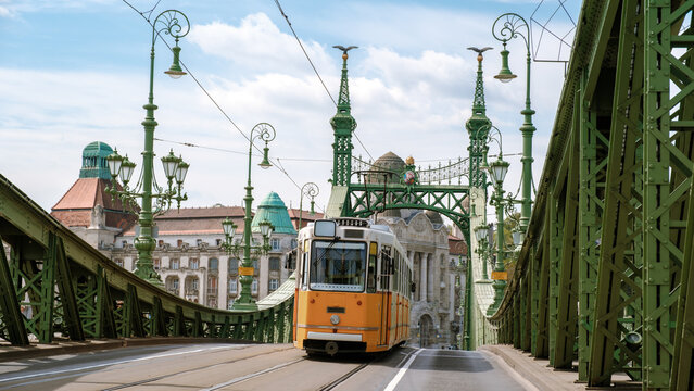 Explore the charm of Budapest with a vintage tram crossing the iconic Liberty Bridge
