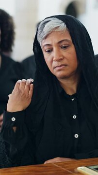 Sad, woman and comfort at funeral with coffin, condolences and memorial service for deceased. Family, consoling and widow with casket at church for rip, final goodbye and burial for farewell ceremony