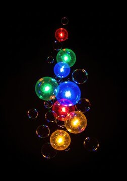 Vibrant glowing spheres and shimmering bubbles float elegantly against a deep black backdrop, creating an annual festive celebration mood, holiday, gradient, bubble