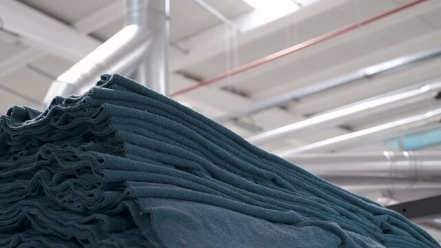 Automated industrial textile weaving machinery operating with colorful thread spools in modern factory