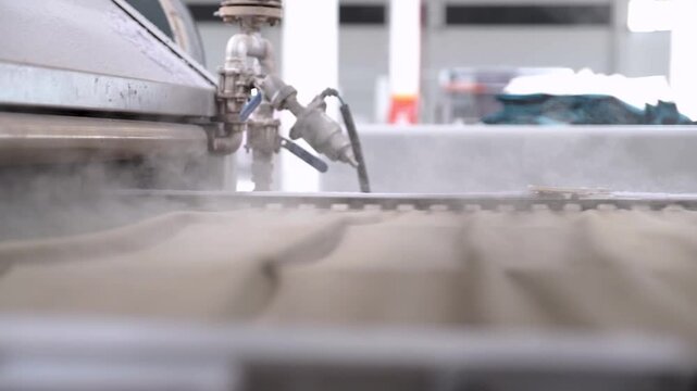 Automated industrial textile weaving machinery operating with colorful thread spools in modern factory