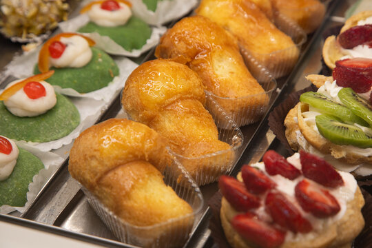 Baba al rum. Assortment of traditional Sicilian pastries with marzipan and candied fruit.
