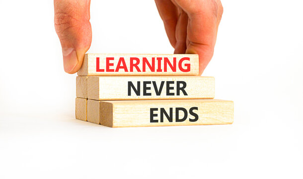 Learning never ends words symbol. Concept words Learning never ends on beautiful wooden blocks. Beautiful white background. Business support motivational and learning never ends concept. Copy space.