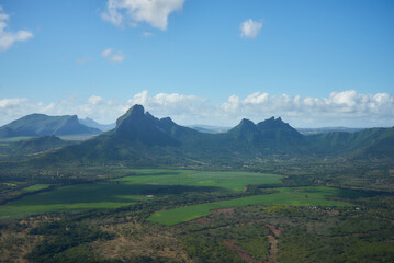 Obraz premium A gorgeous mountain landscape of Mauritius featuring lush green peaks, dramatic ridges, and breathtaking tropical scenery. The image showcases the island's volcanic terrain, natural beauty, and views