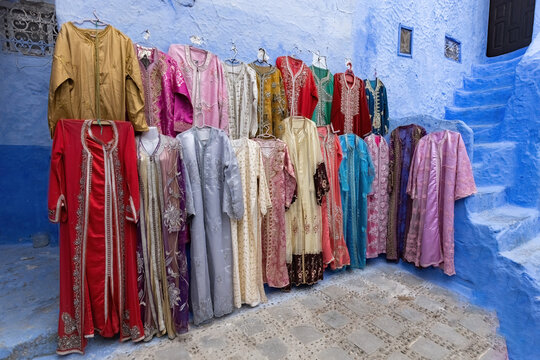 Collection of traditional long arabic dresses for sale on the street of blue town Chefchaouen in Morocco