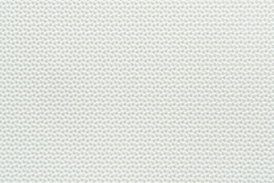 Clean white textured background surface with subtle fine grid mesh pattern close up.