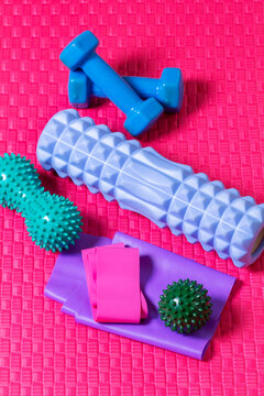 Home Fitness Equipment with Foam Roller, Dumbbells and Resistance Bands on Exercise Mat