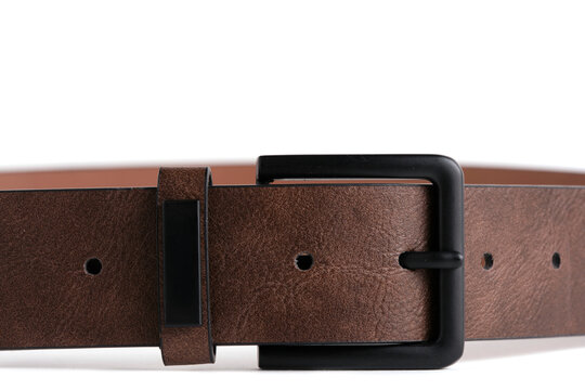 Macro close up view brown leather belt with black matte buckle on white background.
